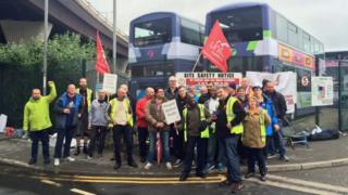 Union members outside a bus depot
