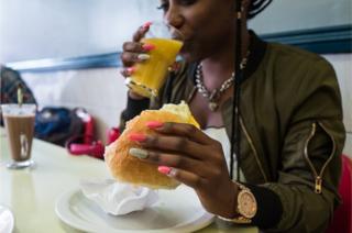 Woman eating and drinking