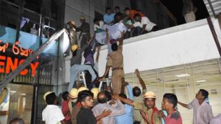 A patient is being shifted as rescue work is in progress after a fire broke out in the Intensive Care Unit (ICU) of SUM hospital in Bhubaneswar, Orissa, India, 17 October 2016.