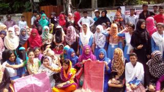 Dozens of male and female students protest at the attack