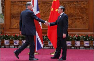 Foreign Secretary Philip Hammond shakes hands with his Chinese counterpart, Wang Yi