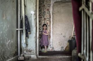 Marium Gabisonia, aged seven-years-old, pauses during a game of tag with her siblings