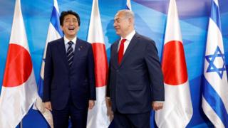 Japan's Prime Minister Shinzo Abe stands next to Israeli Prime Minister Benjamin Netanyahu ahead of a joint meeting, at the Prime Minister's office in Jerusalem