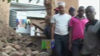 Image shows men next to rubble caused by earthquake in Tanzania on 10 September 2016