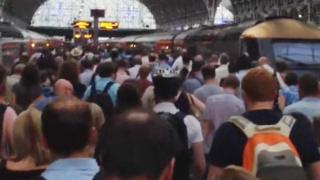 Commuters trying to board a train from London Paddington to Swansea