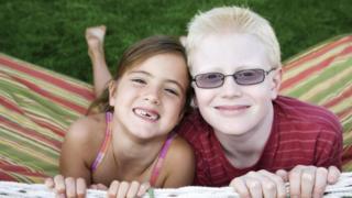 A boy with albinism with his sister