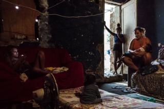 Pamela (pictured on the left) has been living at the occupied building of IBGE for the last 15 years. Pamela's mother, Martha was the second resident to move into this occupied structure. 'Favela' Mangueira community, Rio de Janeiro, Brazil.