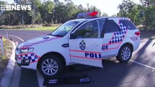 A police car forms part of a roadblock in Queensland