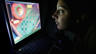 Online gambler looking at computer screen