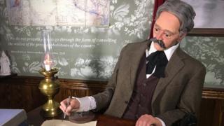 Diorama of Arthur Balfour signing the declaration at the Walled Off Hotel in Bethlehem