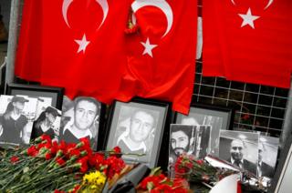 Flowers and pictures of the victims are placed near the entrance of Reina nightclub