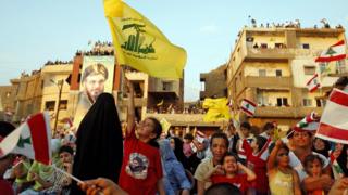 Lebanese children wave Hezbollah and national flags during a ceremony in the Uzai area south of Beirut, 14 July 2007, to mark one year after Hezbollah fired a missile that hit an Israeli navy ship 'Saar 5' two days after the start of the 34-day summer war 14 July 2006.