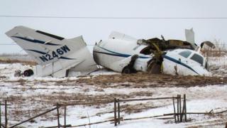 The wreckage of an airplane lies in a field Tuesday, March 29, 2016, in Havre-aux-Maison, Quebec