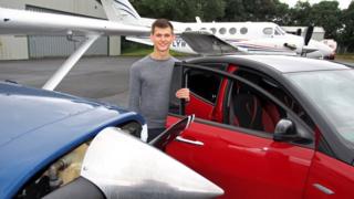 Ross Williams alongside his car and a plane