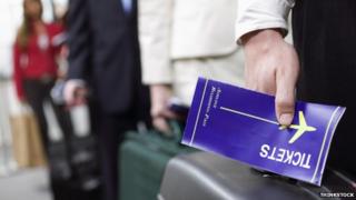 Passenger holding a boarding pass
