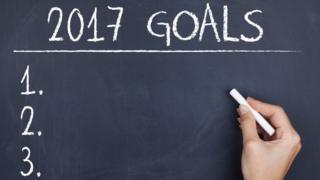 Someone writing down their goals for 2017