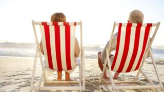 Retired couple sitting in deckchairs