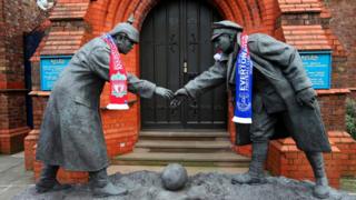 Statues wearing a Liverpool and Everton scarves