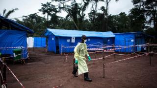 A health worker walks at an Ebola quarantine unit in the DR Congo