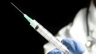 File photo: Doctor holding medical injection syringe