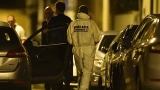 Forensics and police officers cordon off the area next to the house of late French magistrate Jean-Michel Lambert in Le Mans on 11 July