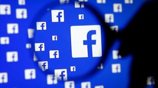 Facebook logo under a magnifying glass
