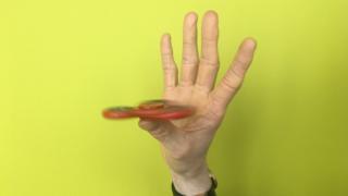Fidget spinner balancing on one thumb