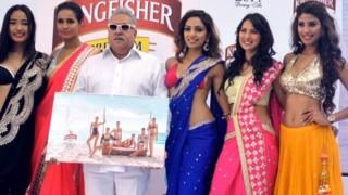 Vijay Mallya next to a line up of glamorous women