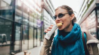 Woman eating a snack on the go