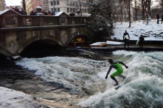 Surfers ride the Eisbach canal