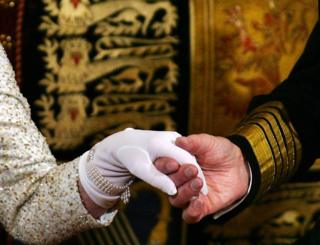 The Queen and Prince Philip hold hands