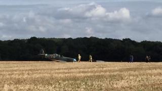 Emergency services with the downed Spitfire in Woodchurch, Kent