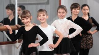 Boys and girls at ballet barre