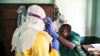 Health workers wear protective equipment as they prepare to attend to suspected Ebola patients at Bikoro Hospital on 13 May 2018