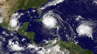 Three tropical storms line up in the North Atlantic approaching the USA.