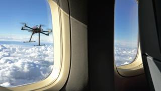 A drone flying next to an aircraft