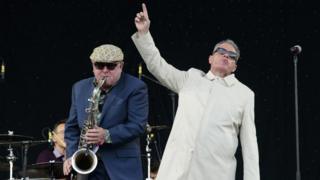 Carl Smyth, left, and Graham McPherson -better known as Suggs from British band Madness - perform at the 2016 Glastonbury music festival