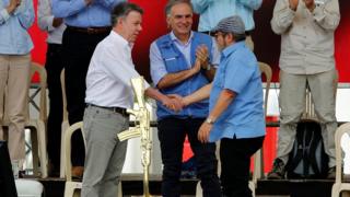 Kolombiya Cumhurbaşkanı Juan Manuel Santos ve FARC lideri Rodrigo Londoño Echeverri el sıkışırken.