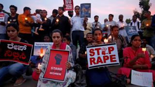 People participate in a candle light vigil as they protest against the rape of an 8-year-old girl in Kathua near Jammu, and a teenager in Unnao, Uttar Pradesh state, in Bengaluru, India on 13 April 2018