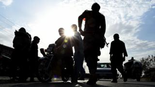 Afghan policemen search commuters at a checkpoint in Lashkar Gah, the capital of Helmand province. October 6, 2016