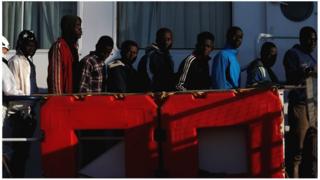 Rescued migrants wait to disembark from the Malta-based NGO Migrant Offshore Aid Station (MOAS) ship Phoenix in Pozzallo on the island of Sicily, Italy, 6 April 2017