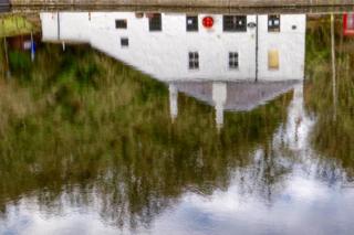 House reflected on water