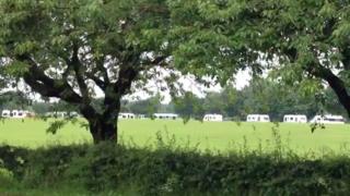 Travellers' vans on a school field