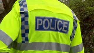 Policeman in high visibility fluorescent jacket