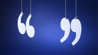 Quotation marks hanging by threads