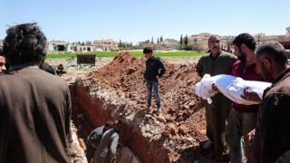 Syrians bury a victim of the chemical attack in Khan Sheikhoun, Idlib province, 5 April