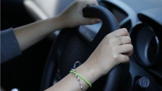Woman holding steering wheel