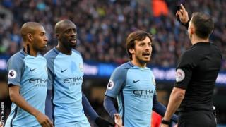 Michael Oliver was surrounded by several Manchester City players after awarding Liverpool a penalty