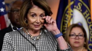 US House Minority Leader Nancy Pelosi reacts during her news conference