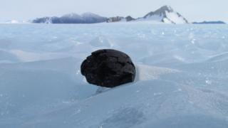 meteorite sitting on ice in Antarctica